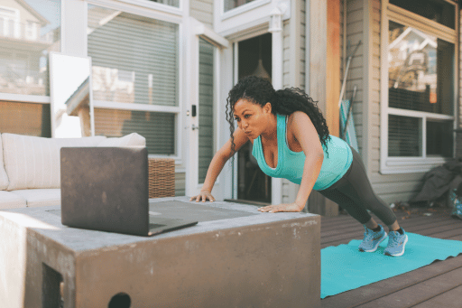 Woman working out from home with a laptop learning about what is liraglutide and its benefits for weight loss