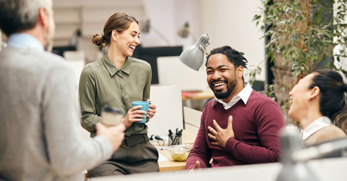 Employees engaged in workplace wellness discussions with Ivím Health corporate programs, improving employee well-being and productivity.