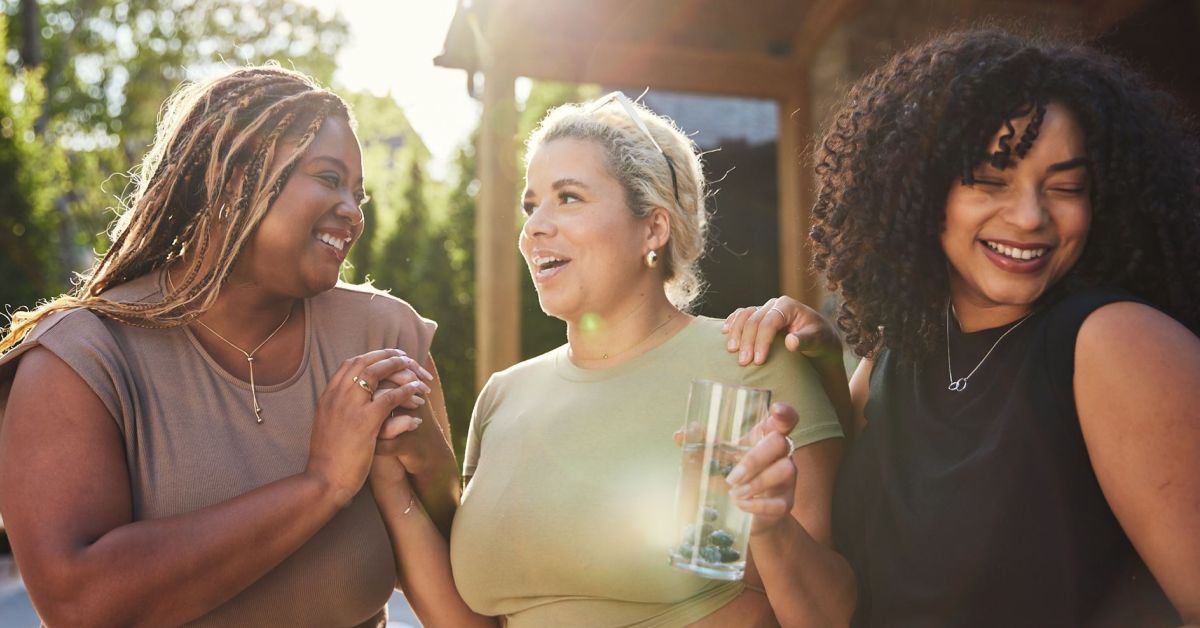 Three women engaging in a supportive conversation about health and obesity treatment for World Obesity Day.